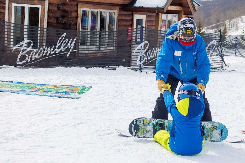 bromley instructor teaching child how to snowboard
